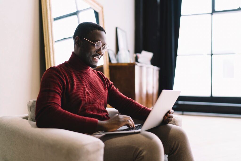 Happy man working on laptop